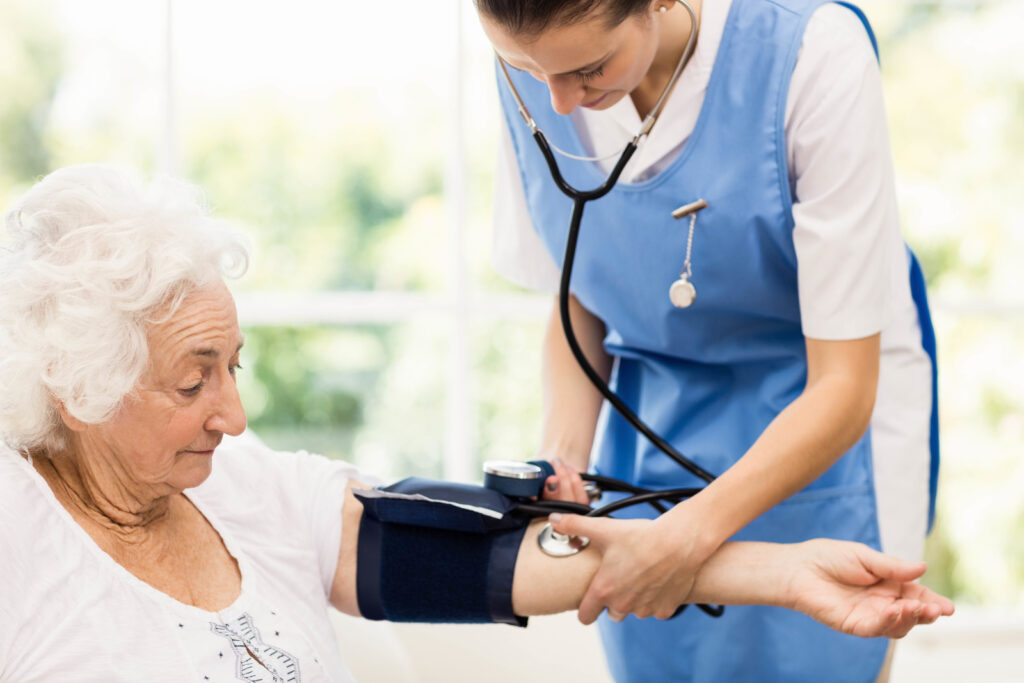 nurse checking the blood pressure of the patient